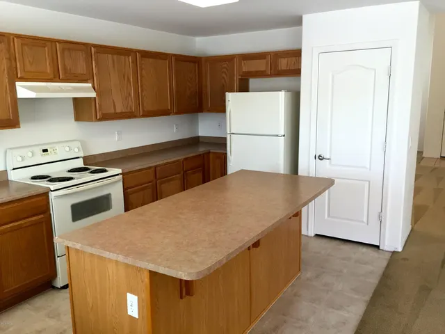 a kitchen with a appliances a refrigerator and a stove