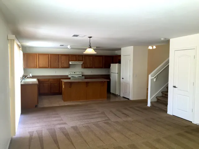 a kitchen with stainless steel appliances granite countertop a stove a sink and a refrigerator