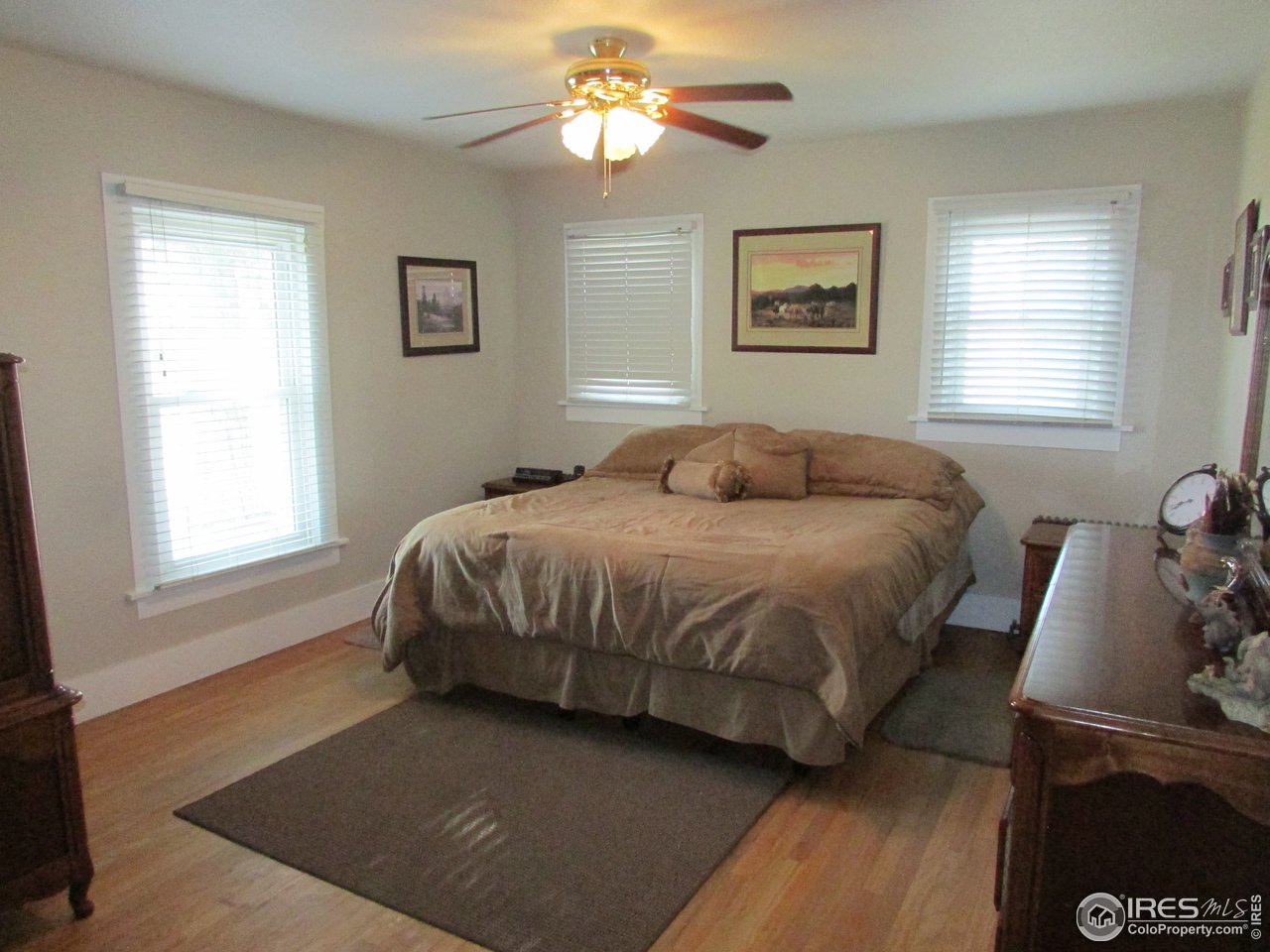 3669 County Road 45 Hudson, CO 80642 - Photo 11 of 25 a bedroom with a bed and wooden floor