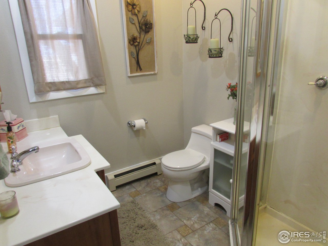 3669 County Road 45 Hudson, CO 80642 - Photo 16 of 25 a white toilet sitting next to a bathroom sink