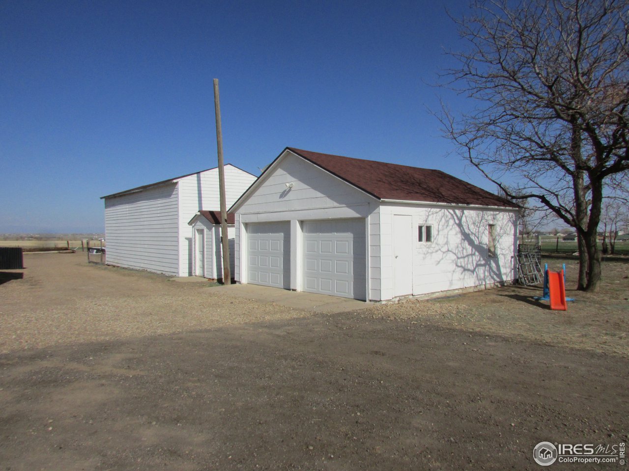 3669 County Road 45 Hudson, CO 80642 - Photo 17 of 25 a view of a house with a yard and garage