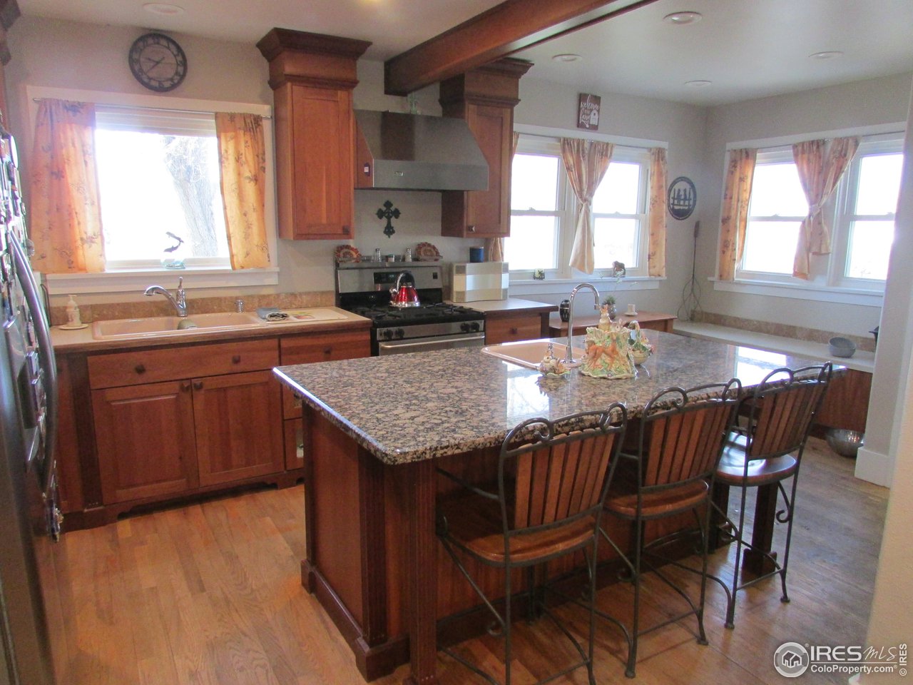 3669 County Road 45 Hudson, CO 80642 - Photo 6 of 25 a kitchen with granite countertop kitchen island a table and chairs in it