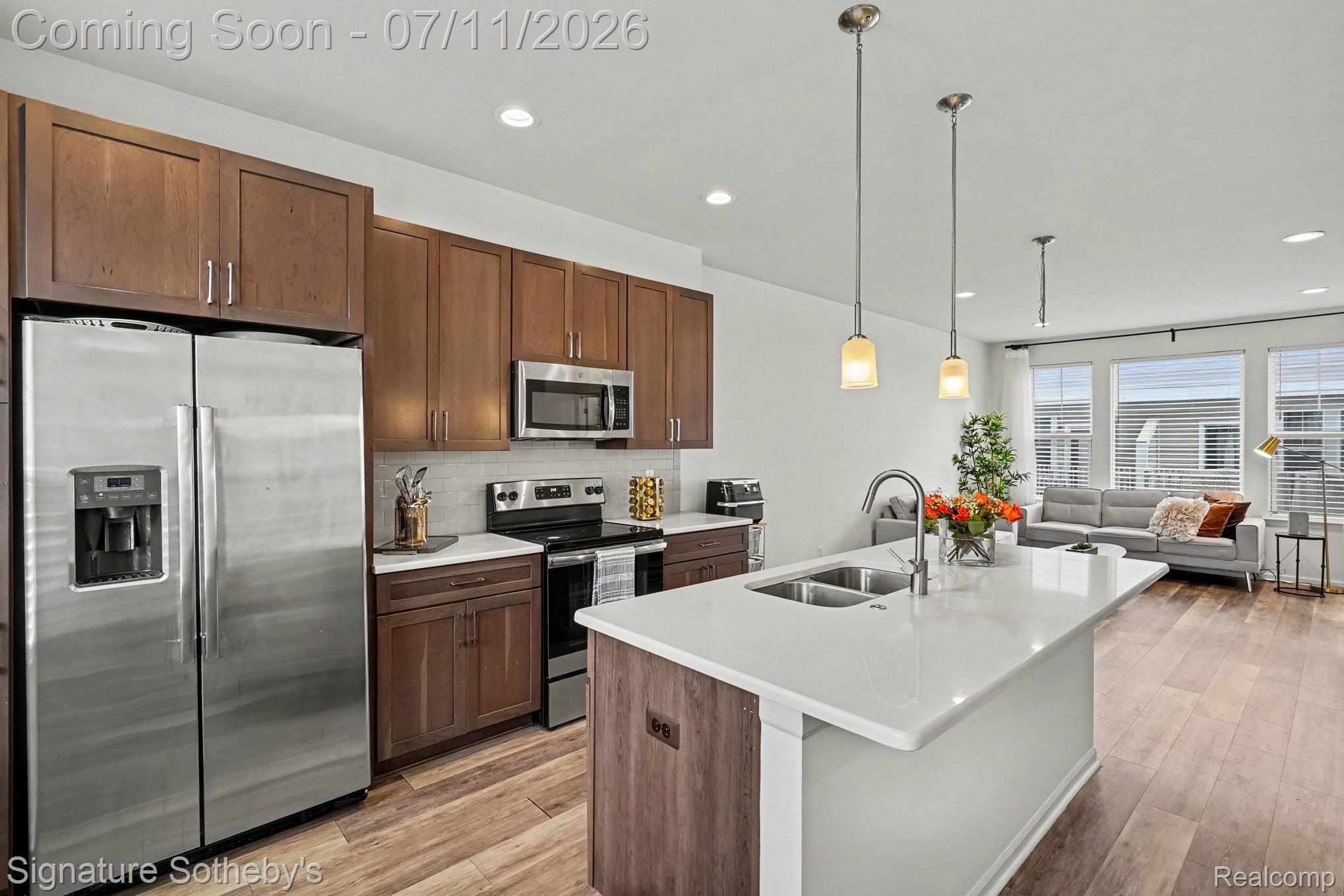 2500 Normandy Road, Unit 40 Royal Oak, MI 48073 - Photo 12 of 26 Kitchen featuring a large island with an integrated double sink and a gooseneck faucet