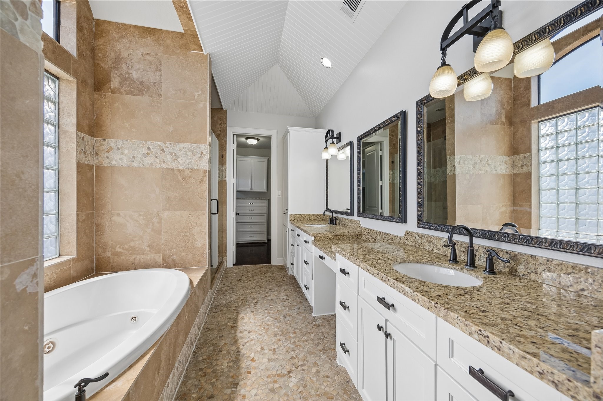 709 Herkimer Street Houston, TX 77007 - Photo 20 of 31 a bathroom with a granite countertop double vanity sink a mirror a bathtub and shower