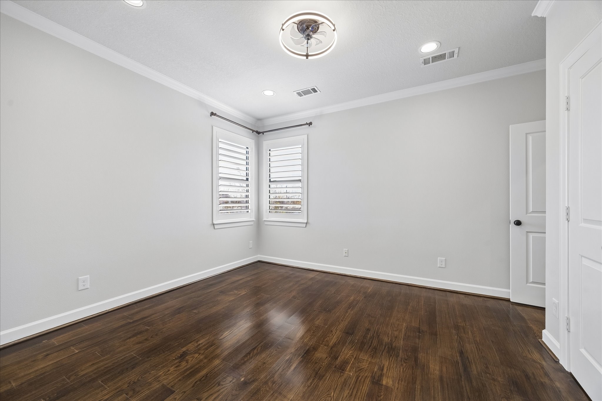 709 Herkimer Street Houston, TX 77007 - Photo 22 of 31 an empty room with wooden floor cabinet and windows