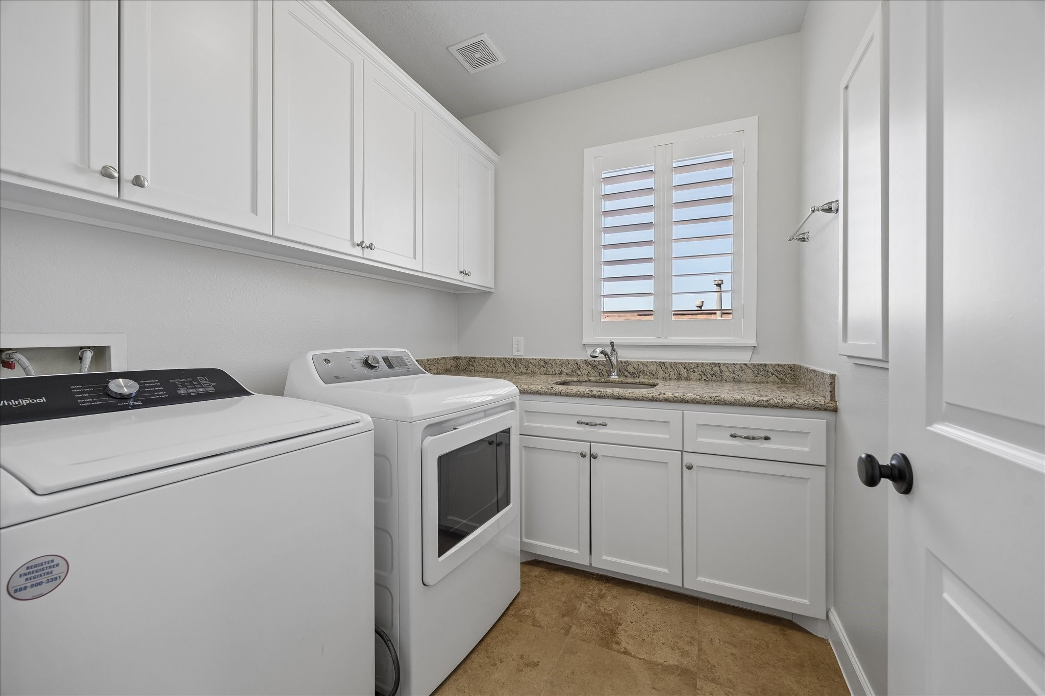 709 Herkimer Street Houston, TX 77007 - Photo 26 of 31 a view of washer and dryer with white cabinets