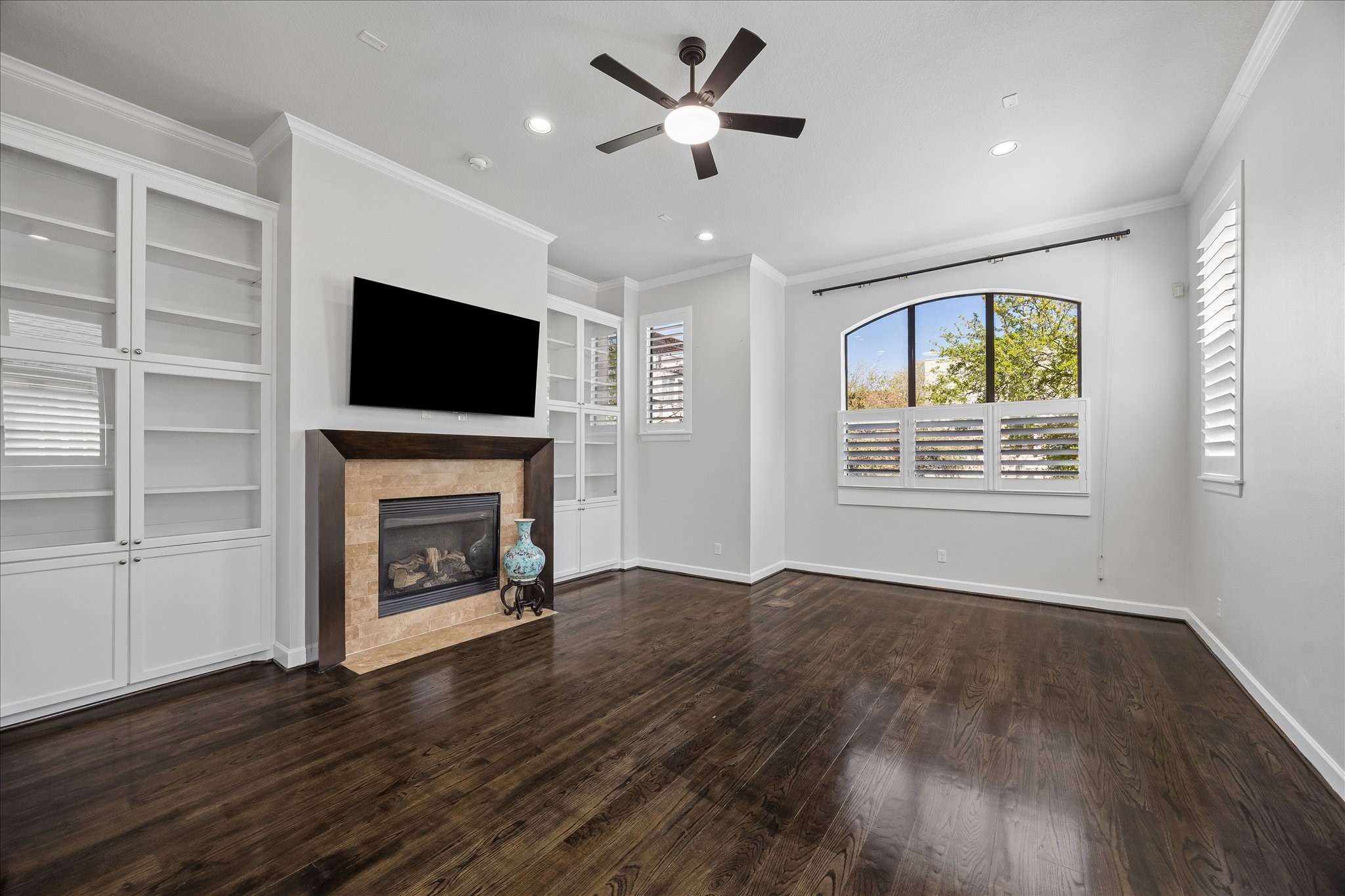 709 Herkimer Street Houston, TX 77007 - Photo 3 of 31 a view of an empty room with a fireplace and a window