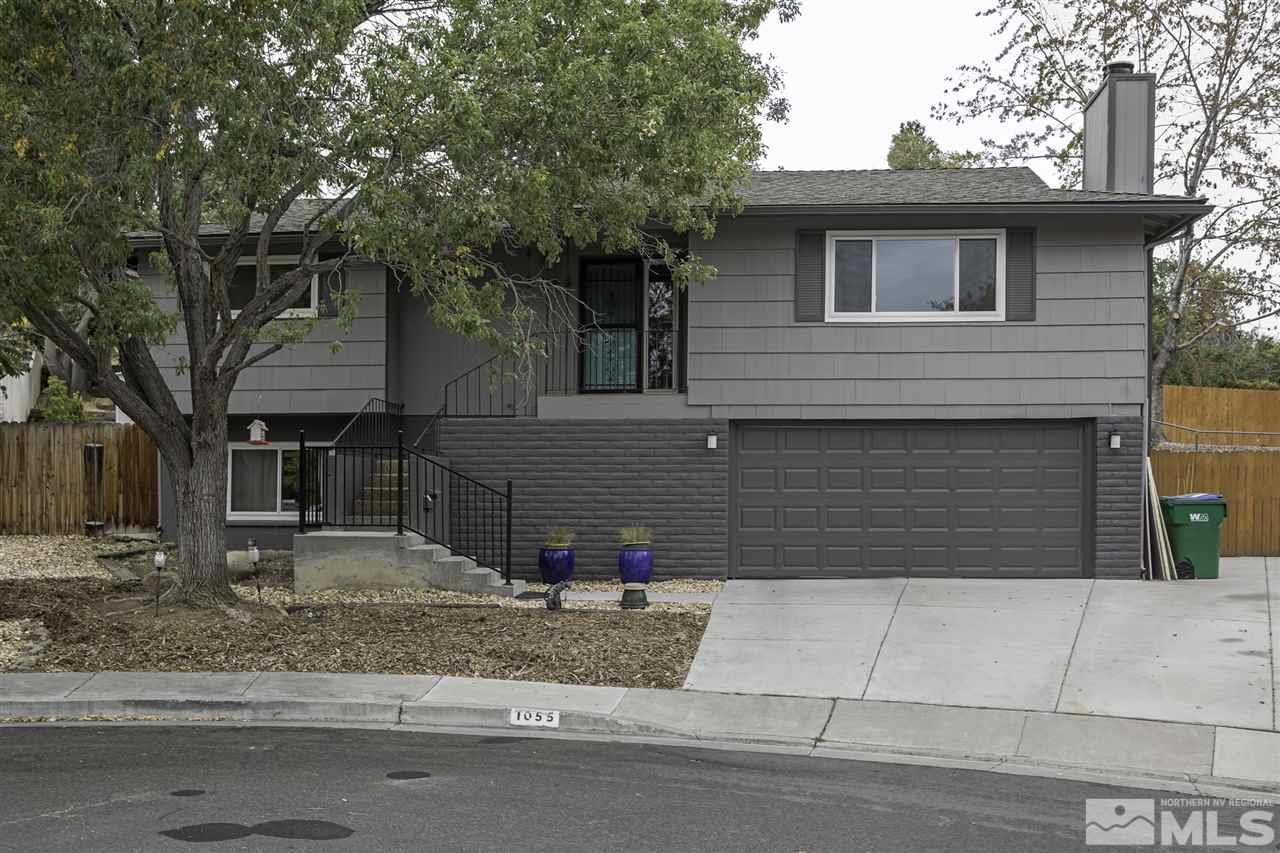 1055 Mark Allen Circle Reno, NV 89503 - Photo 1 of 27 a front view of a house with garage