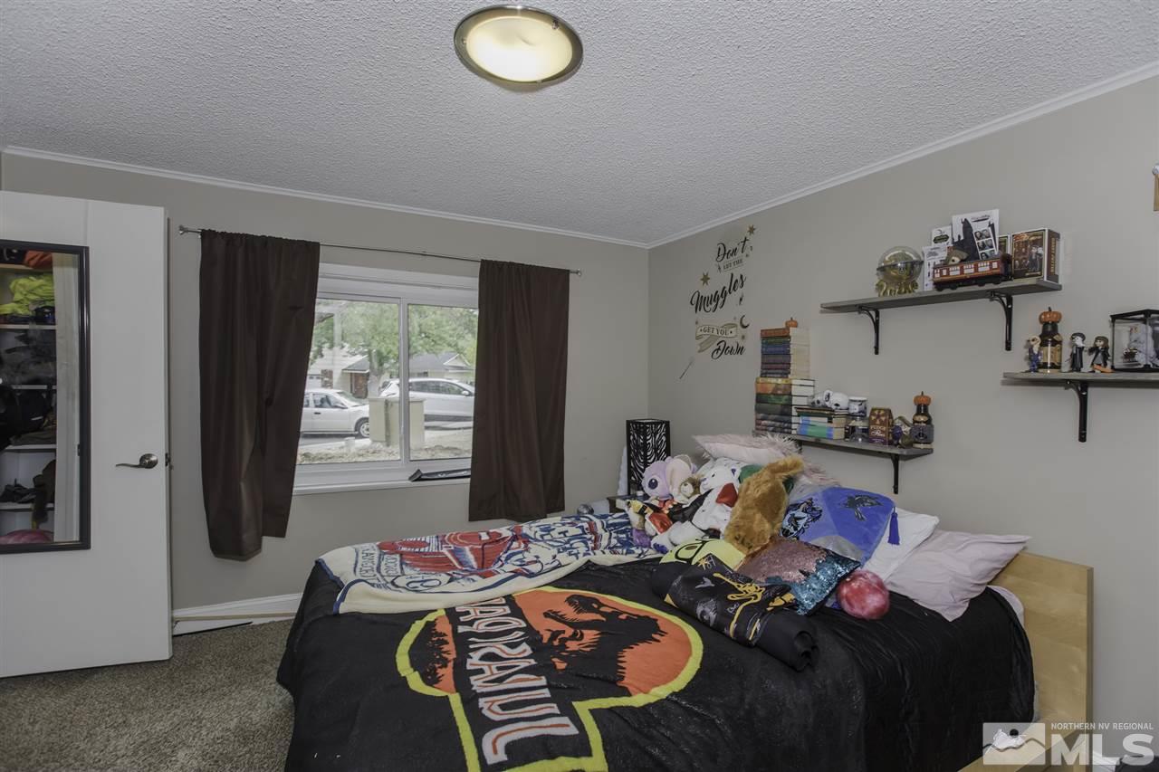 1055 Mark Allen Circle Reno, NV 89503 - Photo 18 of 27 a bed room with furniture and a window
