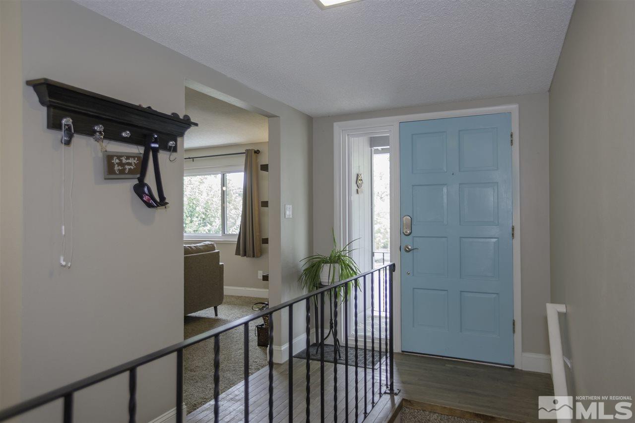 1055 Mark Allen Circle Reno, NV 89503 - Photo 3 of 27 a view of a hallway with wooden floor and staircase