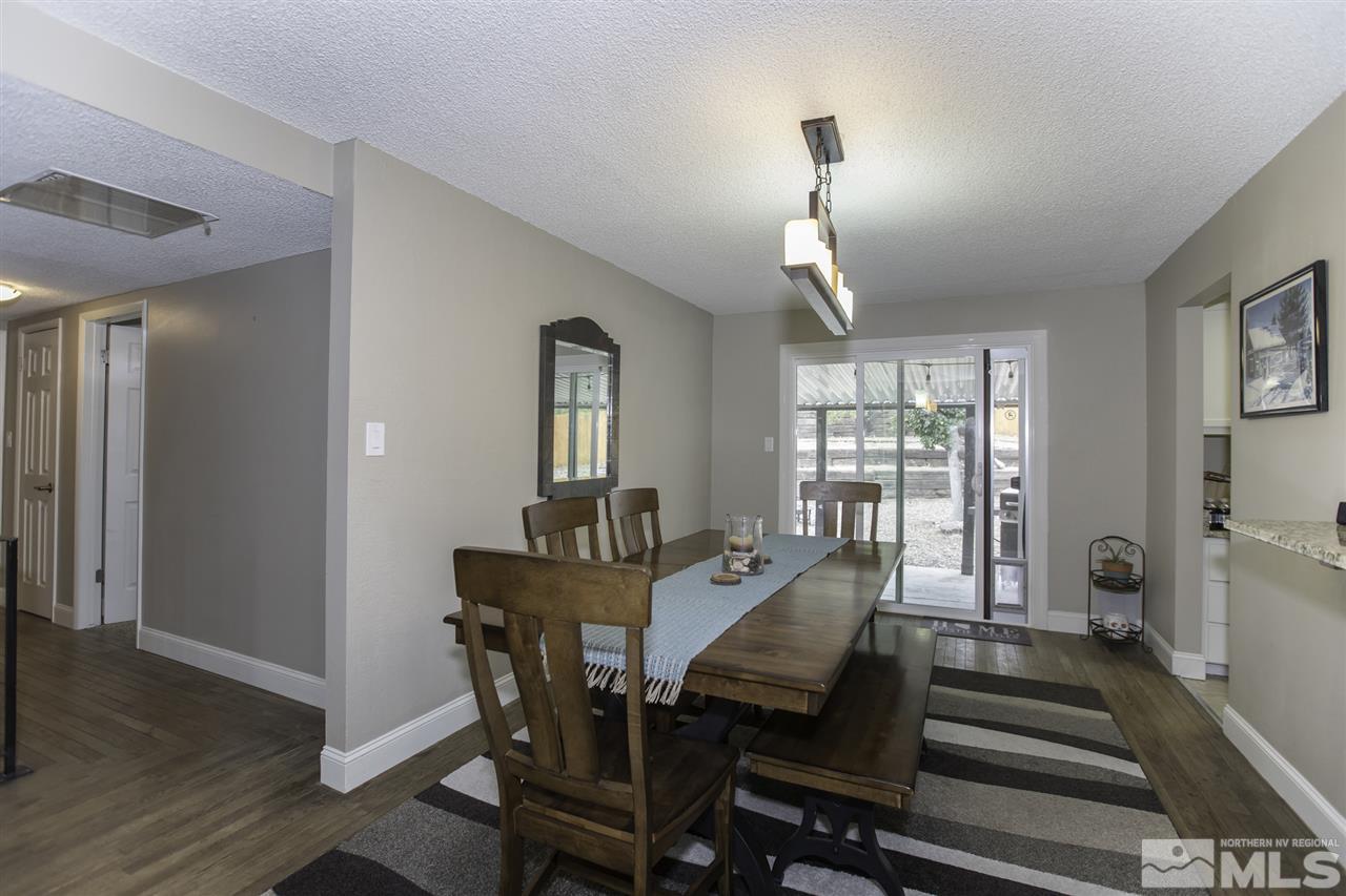 1055 Mark Allen Circle Reno, NV 89503 - Photo 6 of 27 a view of a dining room with furniture window and wooden floor