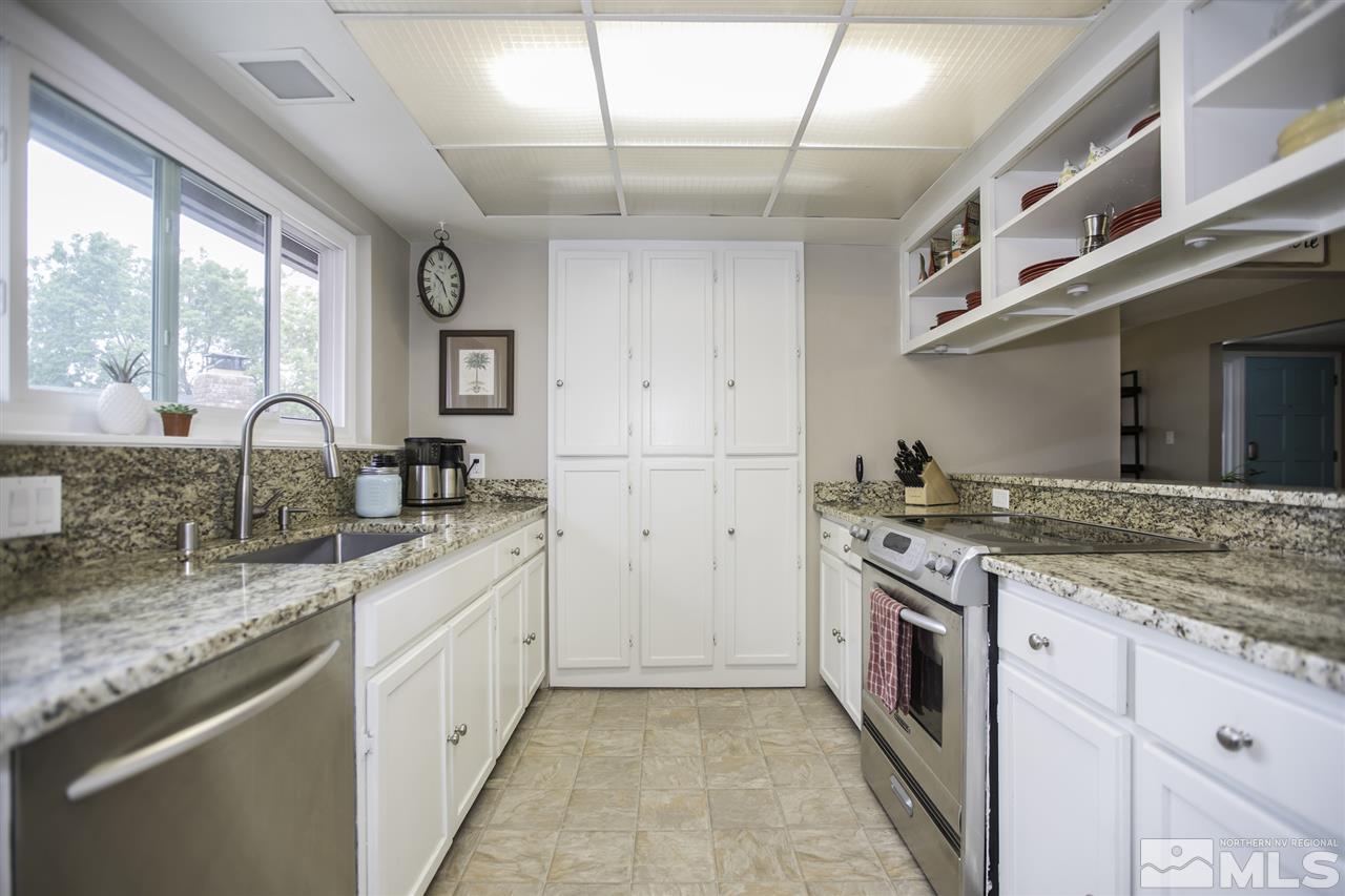 1055 Mark Allen Circle Reno, NV 89503 - Photo 8 of 27 a kitchen with granite countertop a sink stainless steel appliances and cabinets