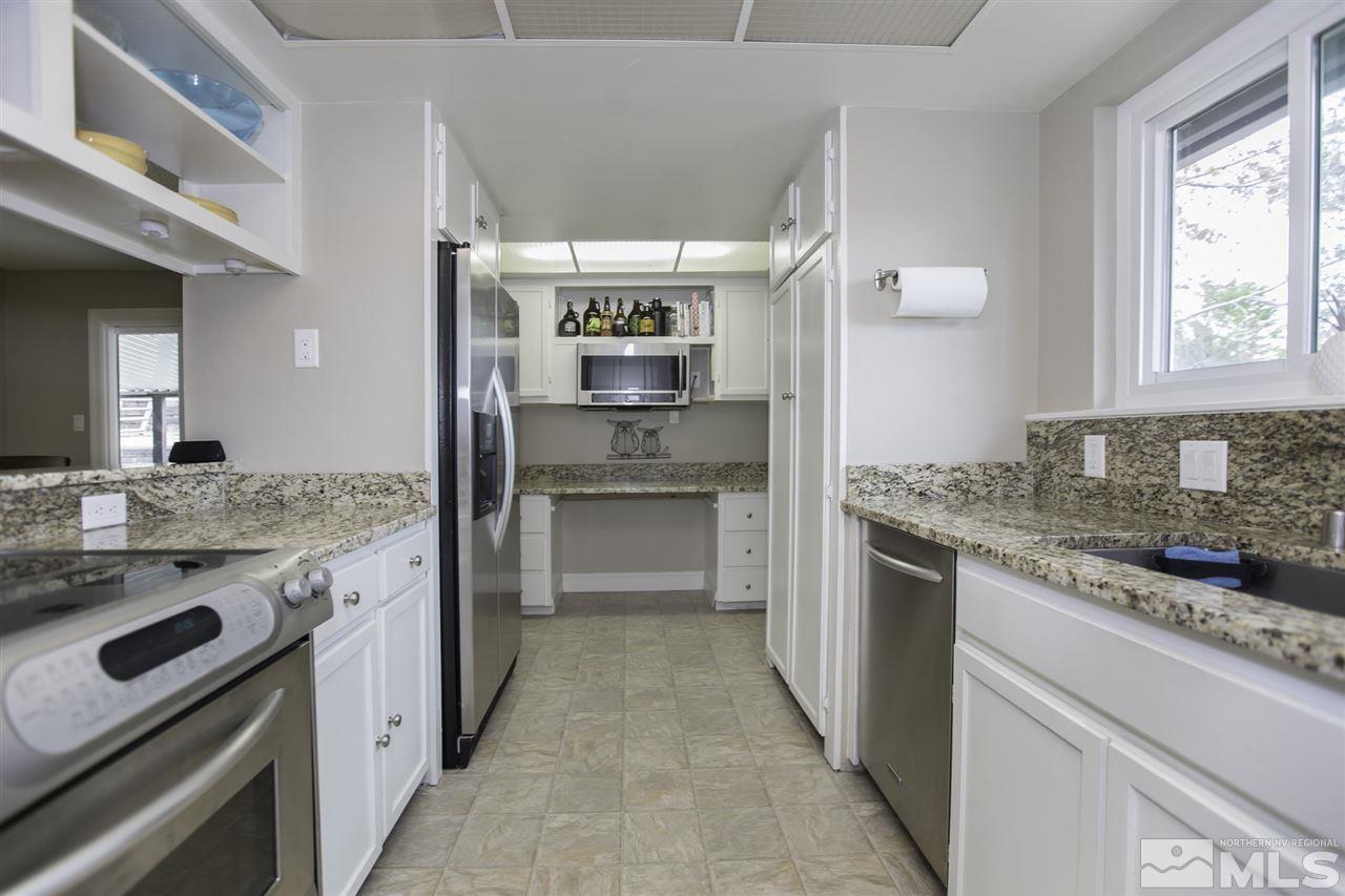1055 Mark Allen Circle Reno, NV 89503 - Photo 10 of 27 a kitchen with a sink stove and refrigerator