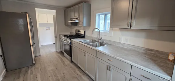 a kitchen with a sink and refrigerator