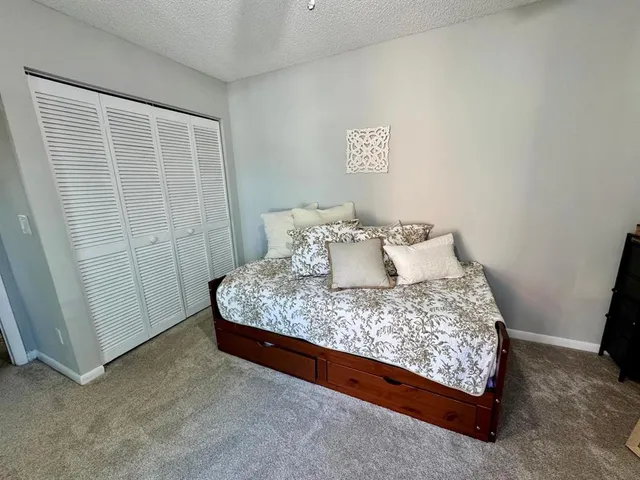 a large bed sitting in a bedroom next to a cabinet