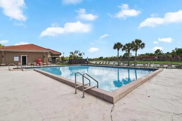 a view of swimming pool with outdoor seating and lake