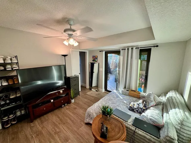 a bedroom with bed and wooden floor