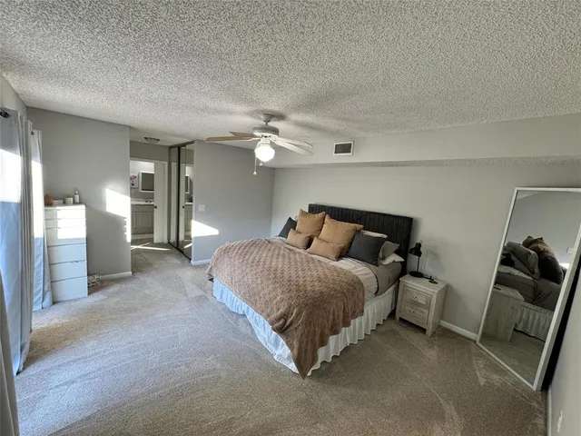 a spacious bedroom with a bed and furniture