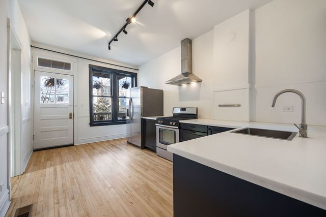 a kitchen with stove a sink and refrigerator