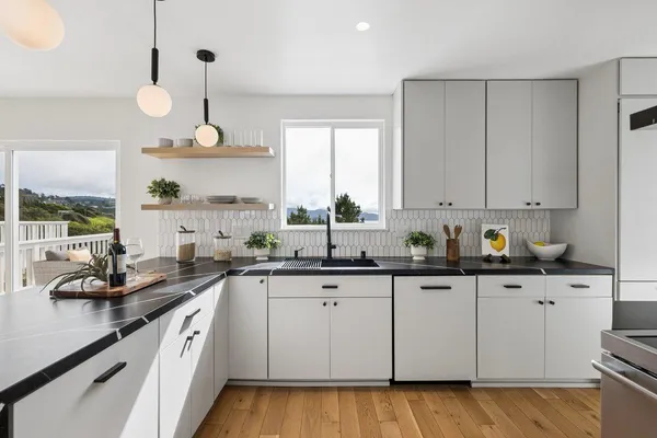 a kitchen with a sink window and cabinets