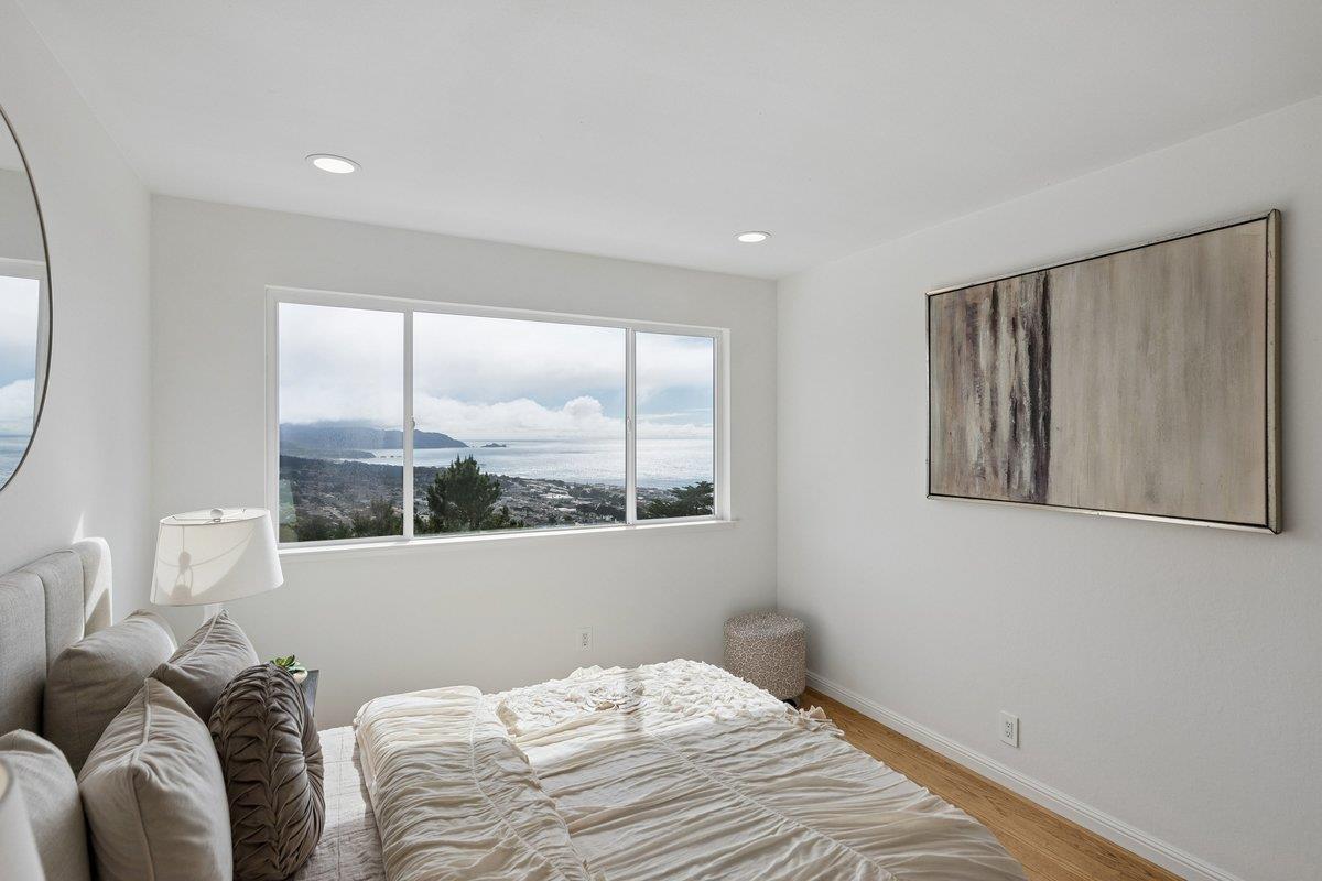 170 Beachview Avenue Pacifica, CA 94044 - Photo 53 of 85 a bedroom with a large bed and a large window