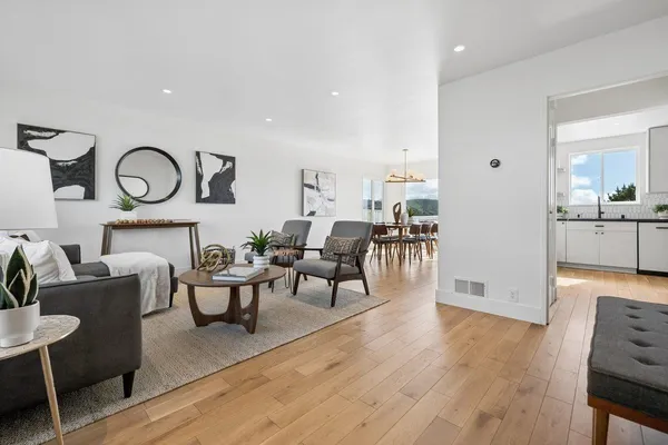 a living room with fireplace furniture and a wooden floor