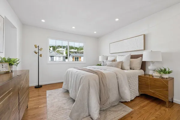 a bedroom with bed and a window