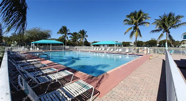 a view of a swimming pool with a table and chairs