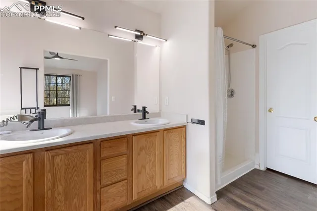 a bathroom with a double vanity sink and a mirror