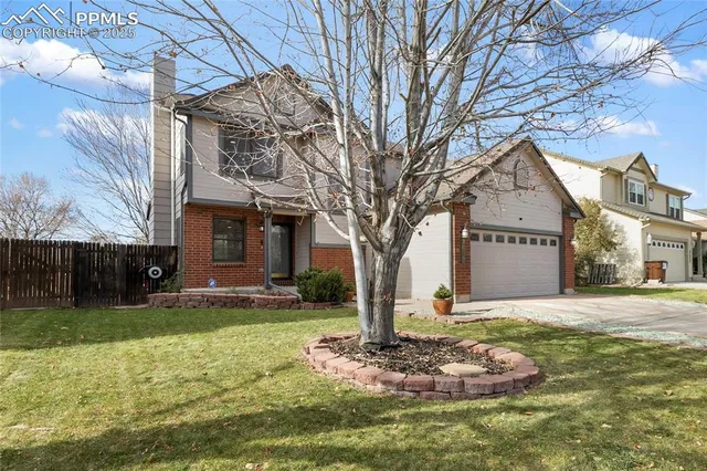 a front view of a house with a yard garage and outdoor seating