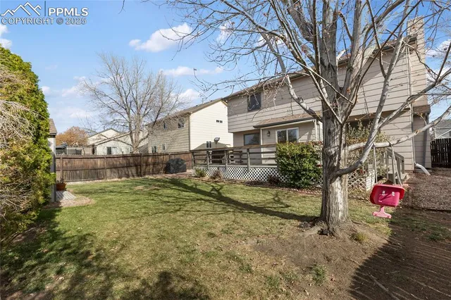 a view of a back yard of the house with a yard