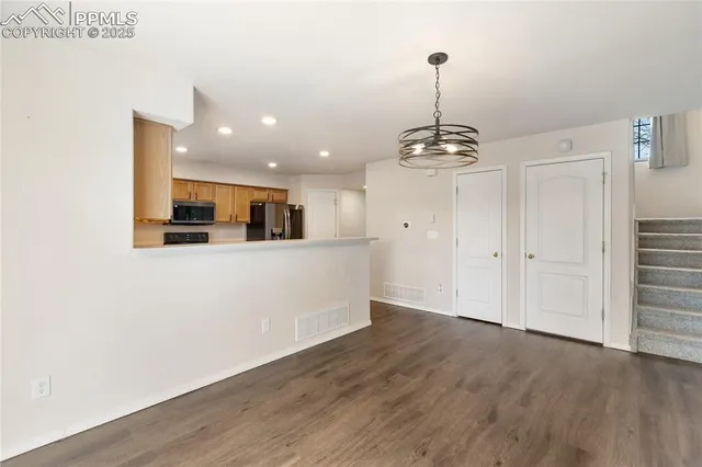 a view of a kitchen with a sink wooden floor and a window