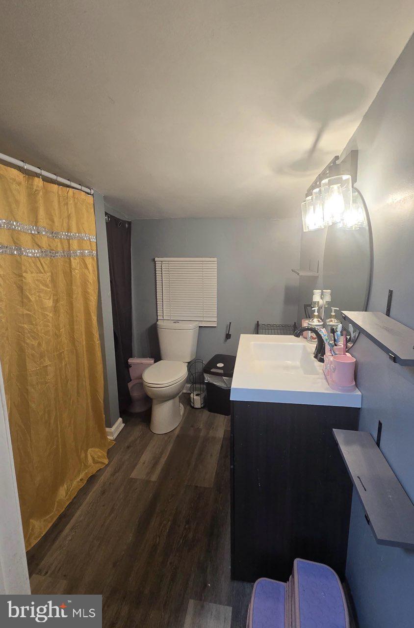 516 10th Avenue Lindenwold, NJ 08021 - Photo 5 of 7 a bathroom with a sink and mirror with toilet