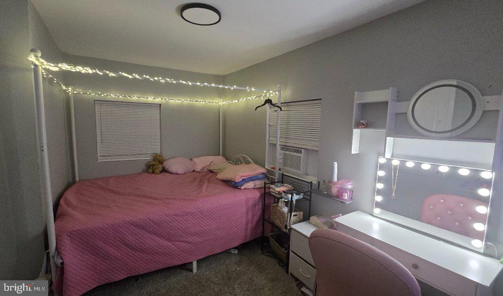 516 10th Avenue Lindenwold, NJ 08021 - Photo 6 of 7 a bedroom with a bed and chandelier