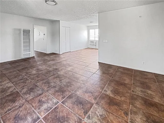 a view of a kitchen with white cabinets