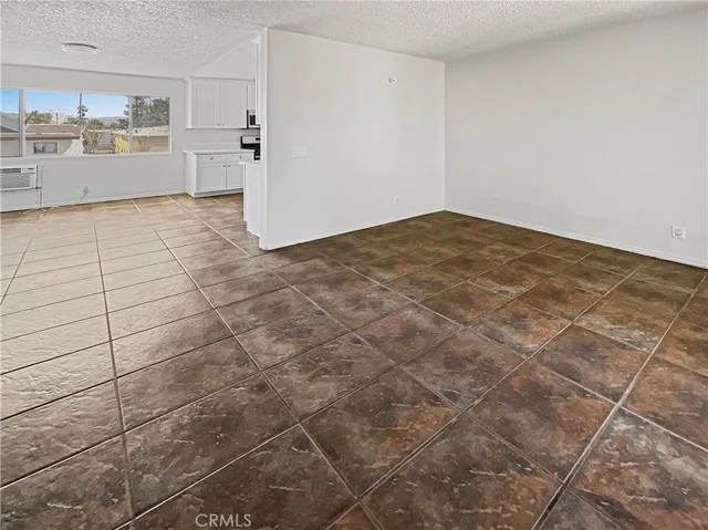 a kitchen with a stove a sink and white cabinets