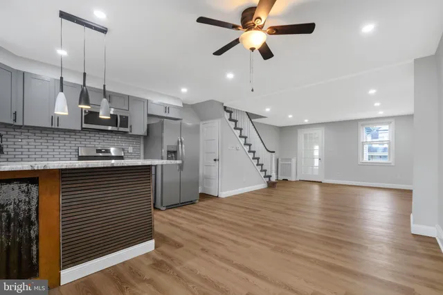 wooden floor in an empty room with a kitchen