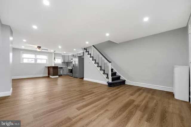a view of kitchen and hall with wooden floor