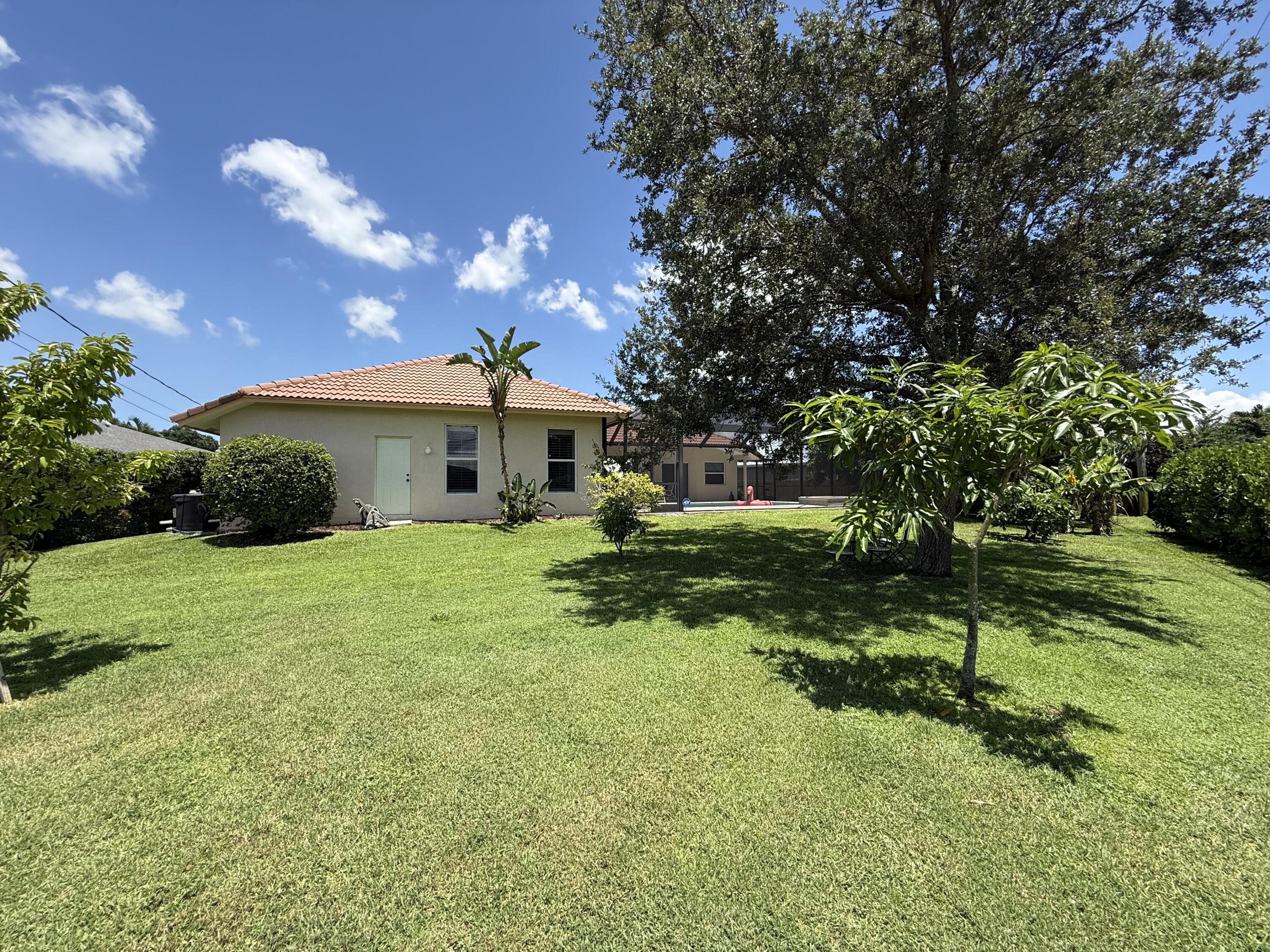 2810 Southeast Tate Avenue Port St. Lucie, FL 34984 - Photo 13 of 43 a front view of a house with a yard