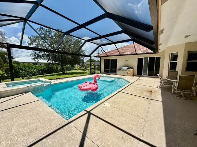 a view of a patio with a table and chairs under an umbrella