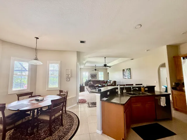 a kitchen with stainless steel appliances granite countertop a sink a stove and a refrigerator