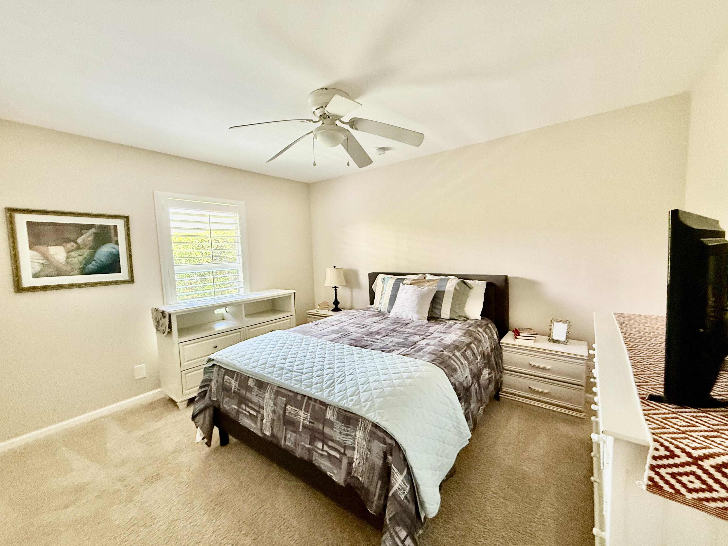 2810 Southeast Tate Avenue Port St. Lucie, FL 34984 - Photo 21 of 43 a bedroom with a bed and wooden floor