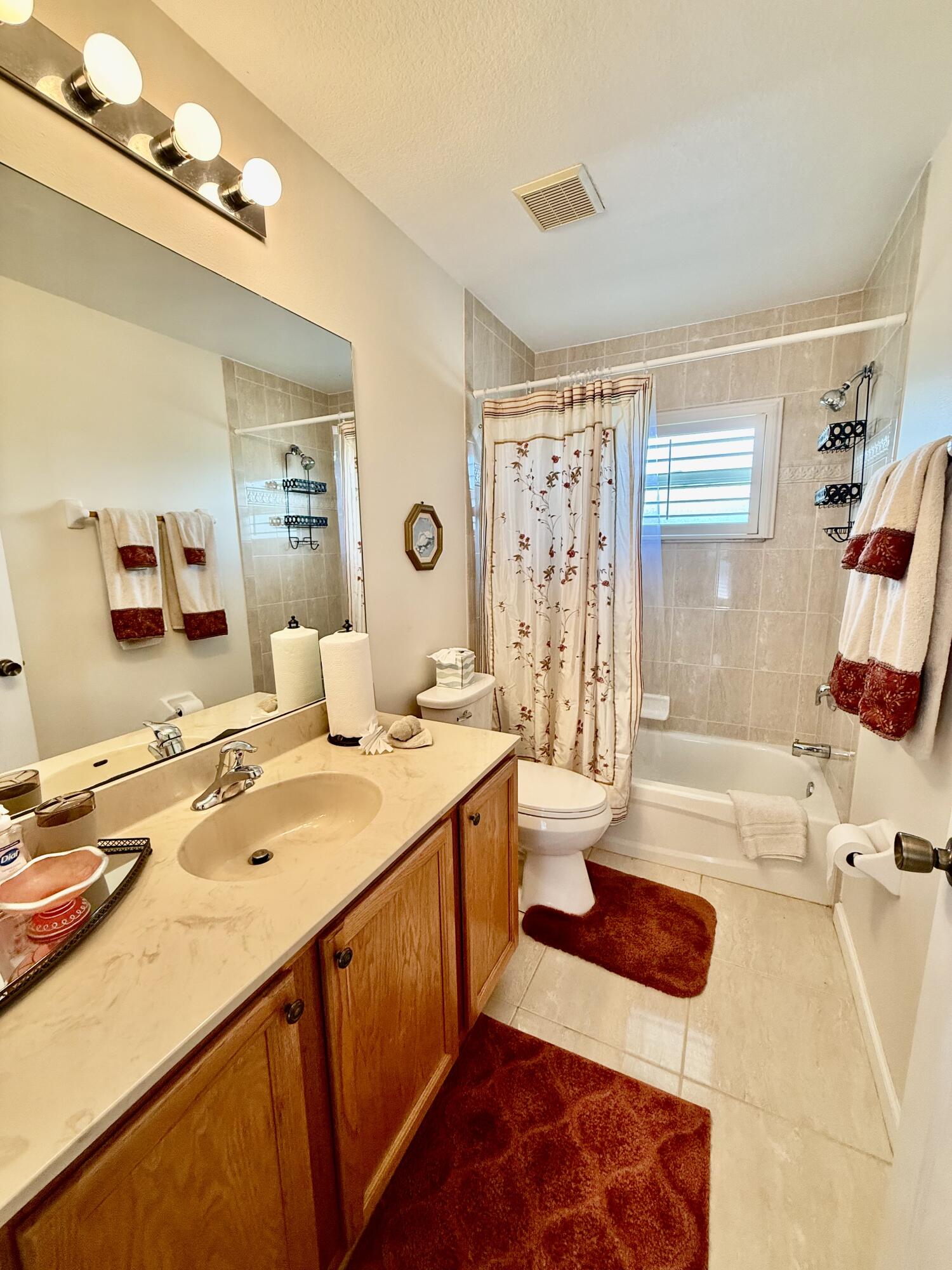 2810 Southeast Tate Avenue Port St. Lucie, FL 34984 - Photo 22 of 43 a bathroom with a sink a toilet and shower