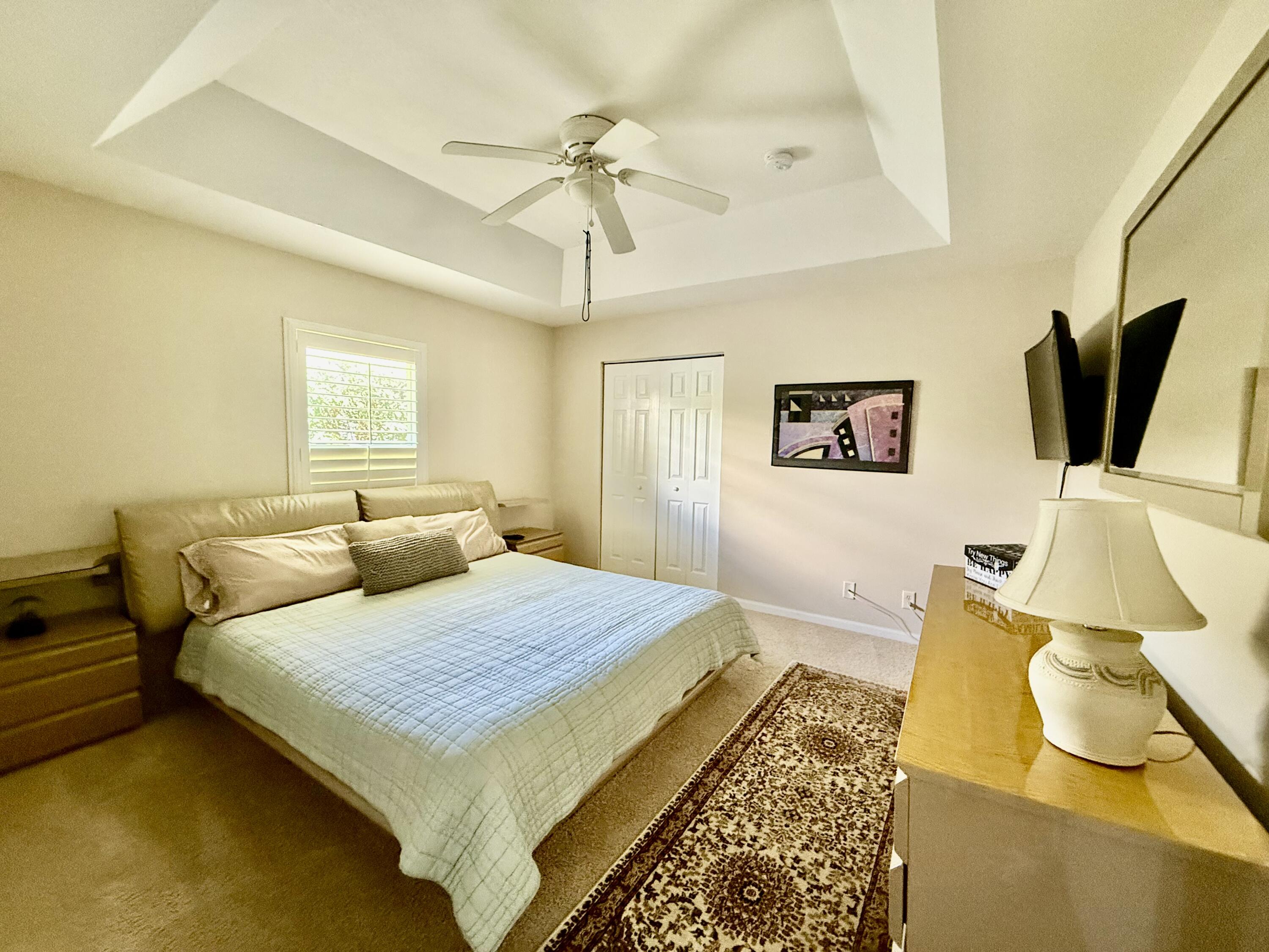 2810 Southeast Tate Avenue Port St. Lucie, FL 34984 - Photo 24 of 43 a bedroom with a bed and wooden floor