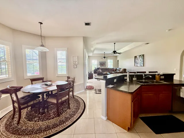 a kitchen with a sink stove and chairs