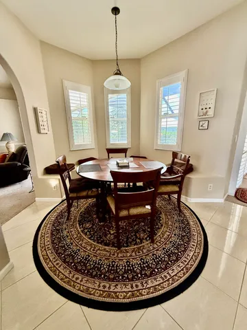 a dining room with table chairs and a chandelier