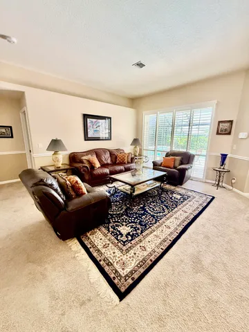a living room with furniture rug and window