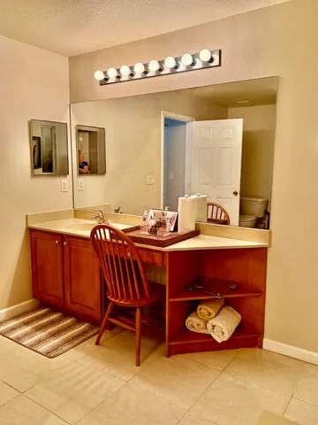 a view of a dining room with furniture and a window