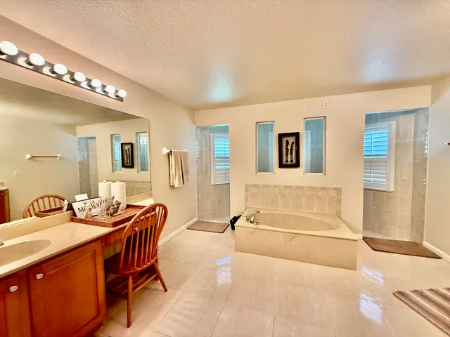 a spacious bathroom with a double vanity sink and a mirror