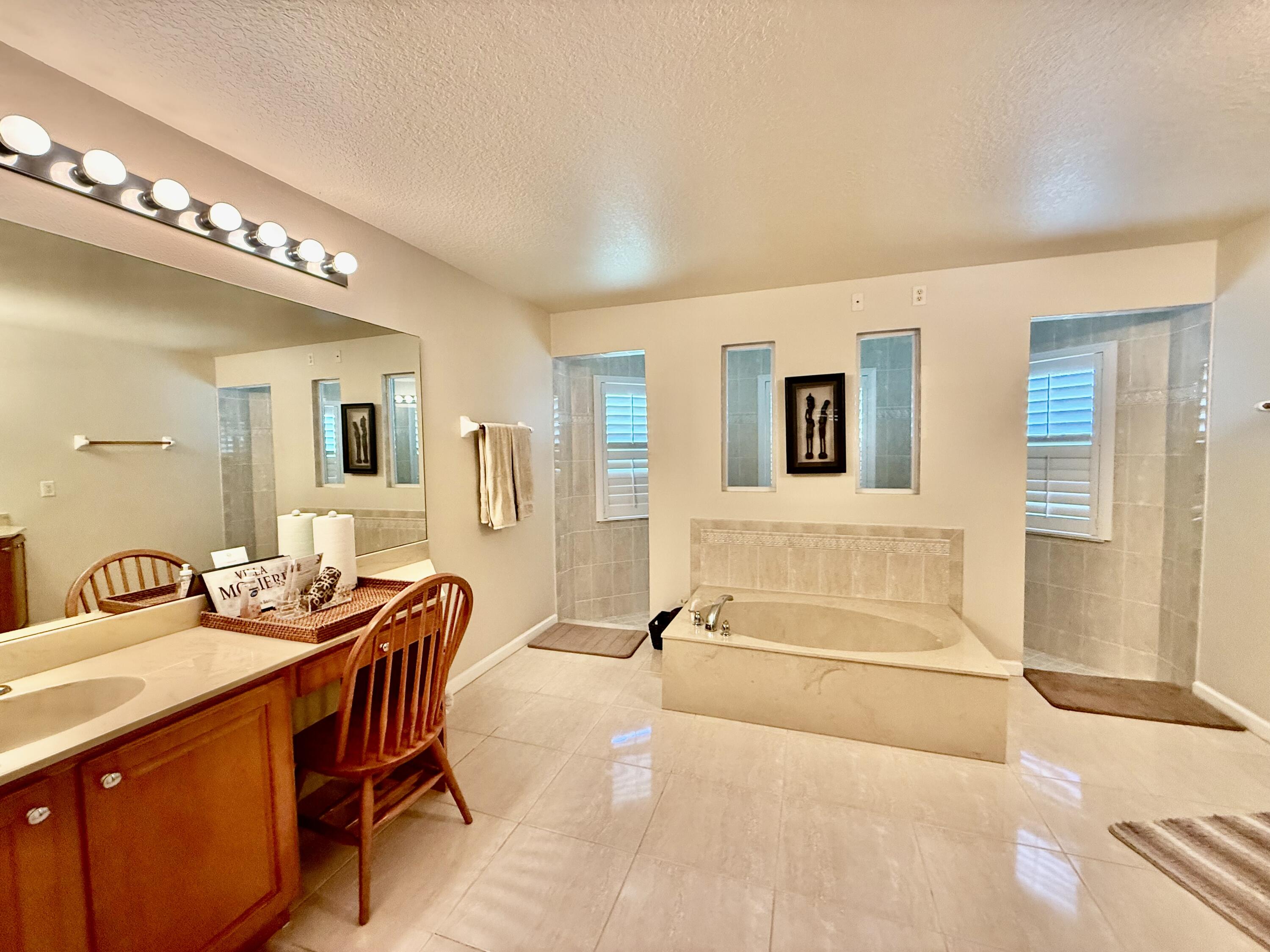 2810 Southeast Tate Avenue Port St. Lucie, FL 34984 - Photo 39 of 43 a spacious bathroom with a double vanity sink and a mirror